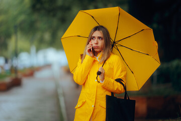 Woman Calling for a Taxi on a Rainy Day. Stressed person trying to find a cab during a storm 

