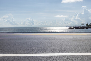Fototapeta premium Asphalt road and beautiful coastline nature landscape under blue sky. Outdoor natural background.