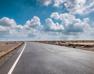 Asphalt highway road and desert natural landscape under the blue sky. Outdoor natural background.