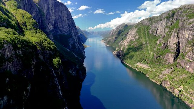 Explore the breathtaking beauty of Norways fjords, where towering cliffs meet serene waters. Lysefjord Lysebotn Norway