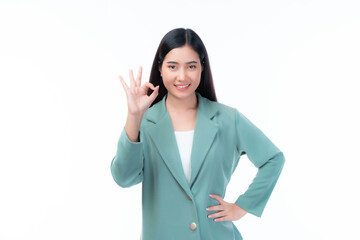 Confident Young Asian Businesswoman in Green Blazer Showing OK Hand Gesture with a Cheerful Smile,...
