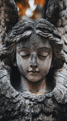 Close up of an angel statue's face with a serene expression.