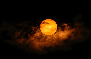 Fiery Sunset: A Celestial Orb in Smoky Hues