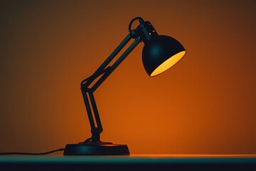 Elegant Black Desk Lamp with Adjustable Arm Illuminating a Warm Orange Background, Perfect for Home Office, Studio, or Creative Workspace Ambiance