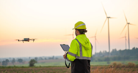 Engineer Specialists Pilot Drone on Wind Turbine Farm. Architectural Engineer and Safety Engineering Inspector Fly Drone at industrial plant.