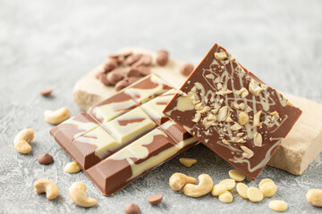 Homemade white milk bar chocolate with cashew nuts on the table
