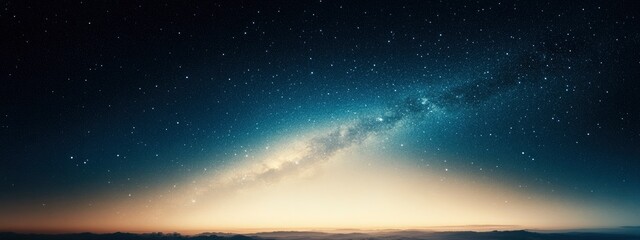 Fototapeta premium A breathtaking view of the night sky showcasing the Milky Way galaxy over a serene landscape at dusk