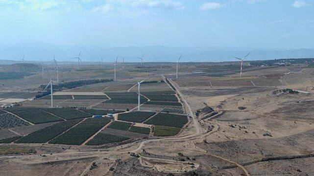 Israel military occupied Golan Heights wind mill farm, agricultural landscape, Drone shot