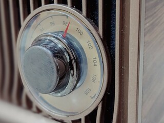 A classic radio exudes vintage charm with its retro design and analog dials.