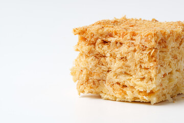 Deliciously sweet coconut candy made from shredded coconut and sugar on a clean white background