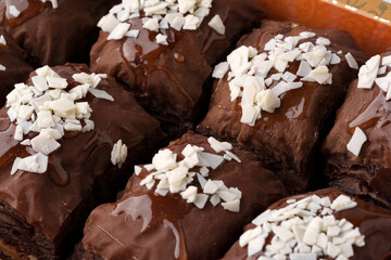 Delicious chocolate desserts topped with coconut flakes at a bakery display
