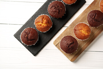 Delightful chocolate and vanilla muffins arranged on wooden serving boards in a bright kitchen setting