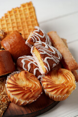 Assorted pastries and sweets arranged on a wooden platter during a food gathering