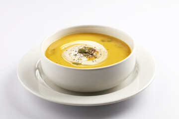 Pumpkin traditional soup with creamy silky texture garnished with pumpkin seeds 