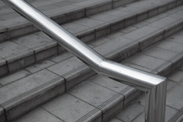 Close up image of stainless steel handrails are installed on the walls and steps.