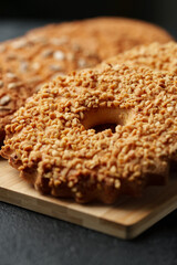 Deliciously crunchy nut-covered pastry served on a wooden board in a cozy cafe setting