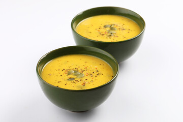 Pumpkin traditional soup with creamy silky texture garnished with pumpkin seeds 