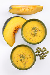 Pumpkin traditional soup with creamy silky texture garnished with pumpkin seeds 