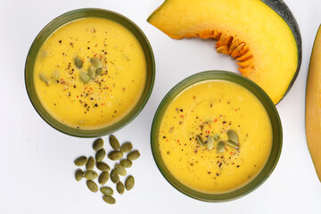 Pumpkin traditional soup with creamy silky texture garnished with pumpkin seeds 