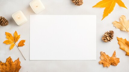Blank White Card Surrounded by Autumn Leaves, Pine Cones and Decorated Candles