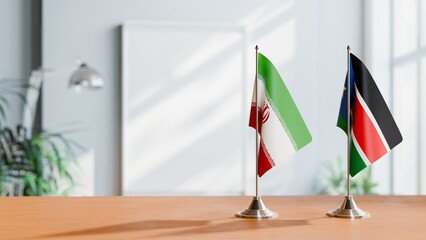FLAGS OF IRAN AND SOUTH SUDAN ON TABLE