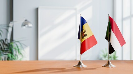 FLAGS OF MOLDOVA AND SUDAN ON TABLE