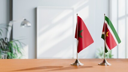 FLAGS OF MOROCCO AND SURINAME ON TABLE