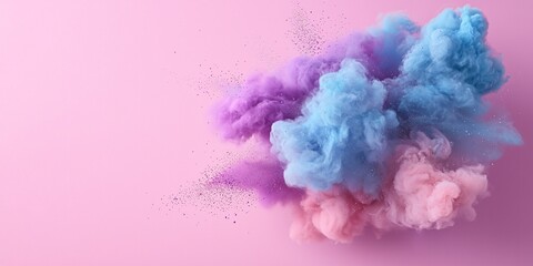 Fototapeta premium A vibrant explosion of colorful powders in blue, pink and purple against a soft pink background, creating an artistic and dynamic visual effect.