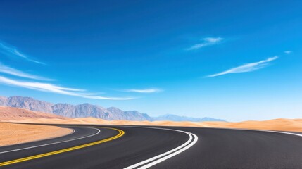 Naklejka premium A winding road through a desert landscape under a clear blue sky.
