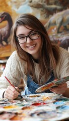 Fototapeta premium A young woman joyfully painting in an artistic studio filled with vibrant colors and creativity.