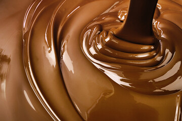 melt dark chocolate background. pouring liquid cocoa dessert