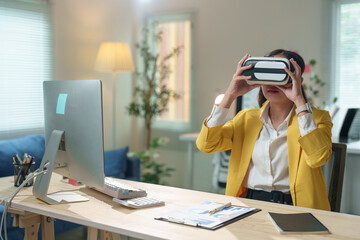 Asian businesswoman wearing virtual reality headset experiencing metaverse technology in modern office, exploring immersive virtual world for business innovation and future digital transformation