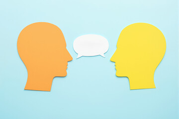 Abstract illustration of orange and yellow silhouettes facing each other with a speech bubble on a light blue background.