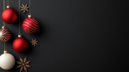 Fototapeta premium Elegant Christmas ornaments in red and white hanging against a dark background, perfect for holiday-themed designs and decorations.