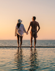 Fototapeta premium Sunset stroll along the tranquil waters of Koh Munnork Island in Rayong, Thailand