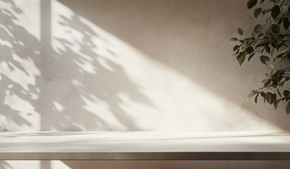 Minimalist beige wall background with sunlight shadows, plant, and empty surface.