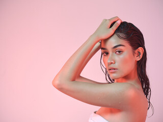 Fototapeta premium Young Woman Pink Background Beauty Shot - Space For Copy