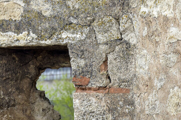 Prat of window opening in an old ruined building. Ancient masonry. Close-up. Copy sace. Selective focus.