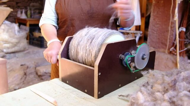 Close-up of Female Artisan Skillfully Carding Wool in Traditional Craft Workshop