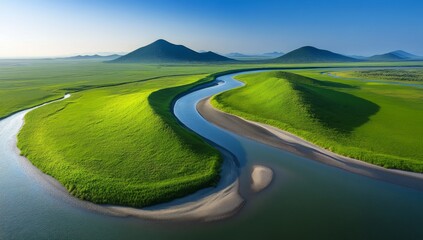 Obraz premium Winding River Flowing Through Vast Grasslands with Green Hills and Clear Blue Sky