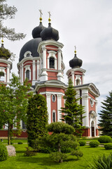 View of Orthodox Cathedral with black domes in monastery against cloudy sky. Kurki Monastery in Moldova was founded in 1773. Concept religion, christianity, orthodoxy. © Marina_Nov