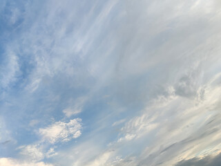 Beautiful unusual cloudy sky. White atmospheric clouds in blue sky. Natural background, texture, abstract pattern. Full frame. Copy space.
