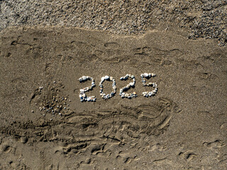 2025 Written with Stones on Sandy Beach by the Sea