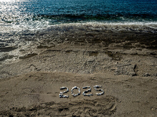 2025 Written with Stones on Sandy Beach by the Sea