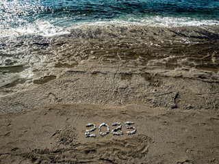 2025 Written with Stones on Sandy Beach by the Sea