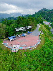 Aerial drone view of  mountain viewpoint surrounded with greenery rainforest at Wang Kelian, Perlis, Malaysia.