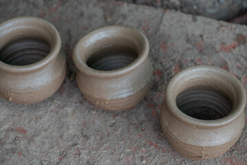 Hands of a potter at work. Potter making ceramic mug on the pottery wheel