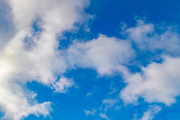 A few light cumulus clouds in a clear blue sky. summer bright image of the sky.