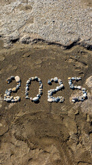 2025 Written with Stones on Sandy Beach by the Sea