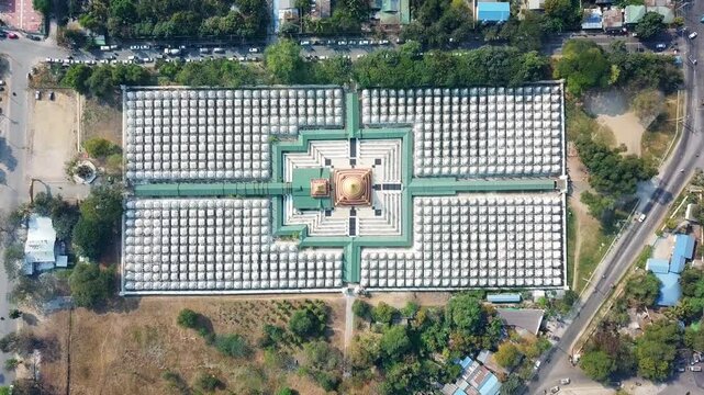 Aerial overhead shot showcases the mesmerizing arrangement of white stupas at the Sandar Mu Ni pagoda in Mandalay, Myanmar, highlighting the symmetrical layout and the central golden structure,